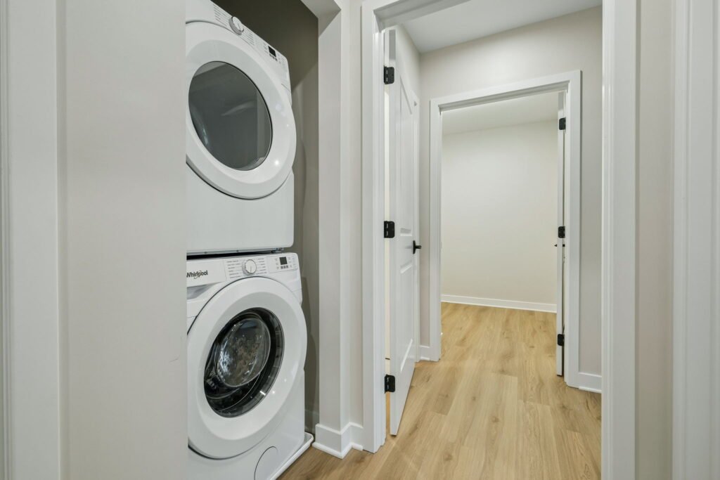 In-unit stacked washer and dryer off the hallway