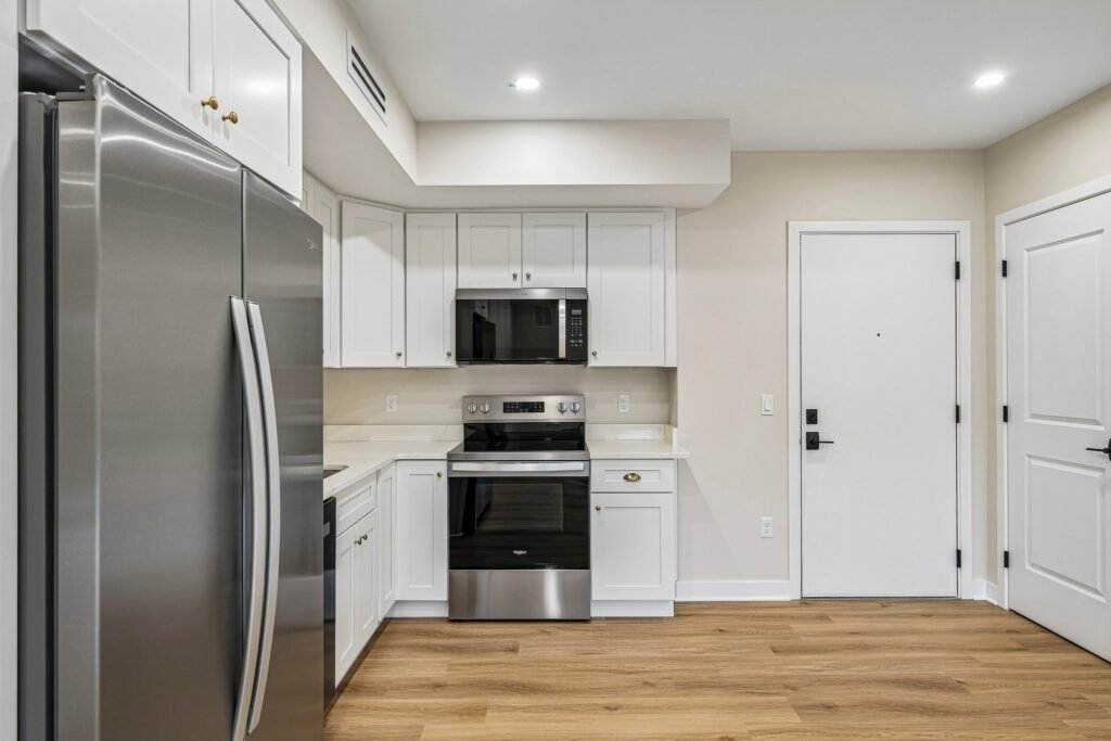 Kitchen with stainless steel appliances and white shaker cabinetry