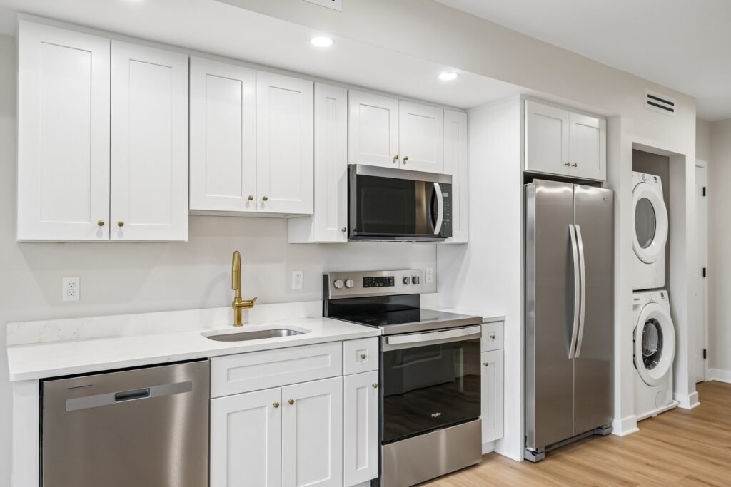 Galley kitchen with in-unit stacked washer and dryer